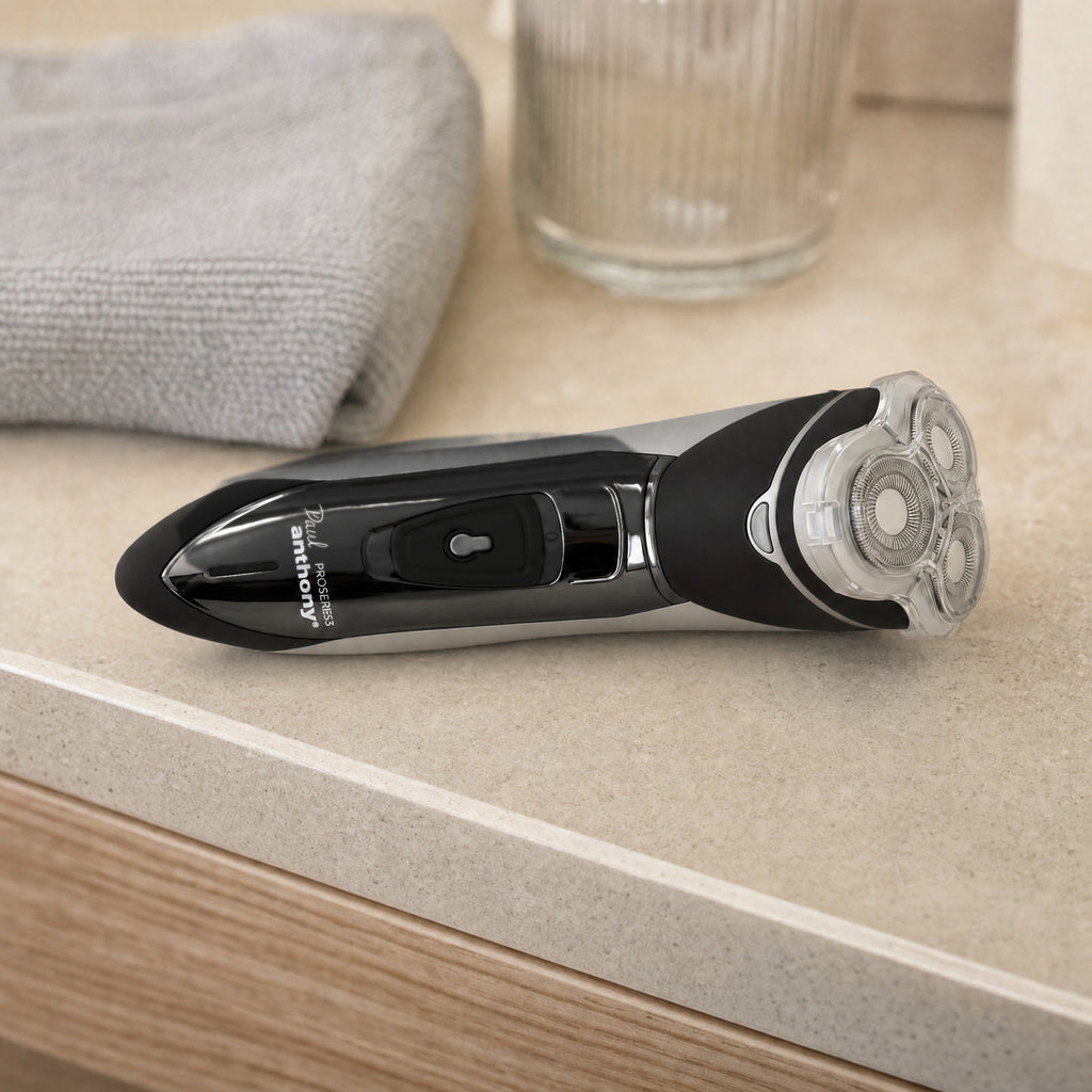 Paul Anthony Mens Rotary Shaver Cordless Rechargeable 3 Titanium Heads LED New — resting on a shelf in context