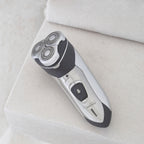 Mens Rotary Shaver Cordless Rechargeable Silver 3 Titanium Heads Trimmer New — cordless, at rest on a bathroom shelf