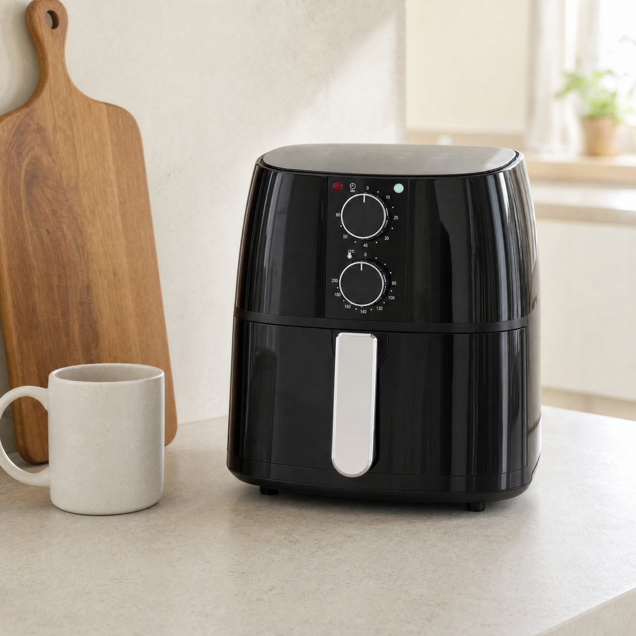 Domestic King 4L air fryer standing on a kitchen worktop next to a mug, showing how compact its footprint is