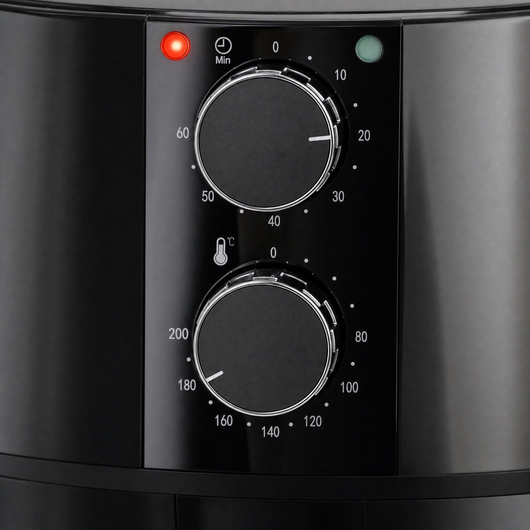 Close-up of the Domestic King 4L air fryer control panel: a 60 minute timer dial set to 20 minutes and a temperature dial set to 180C, with the red pilot light lit