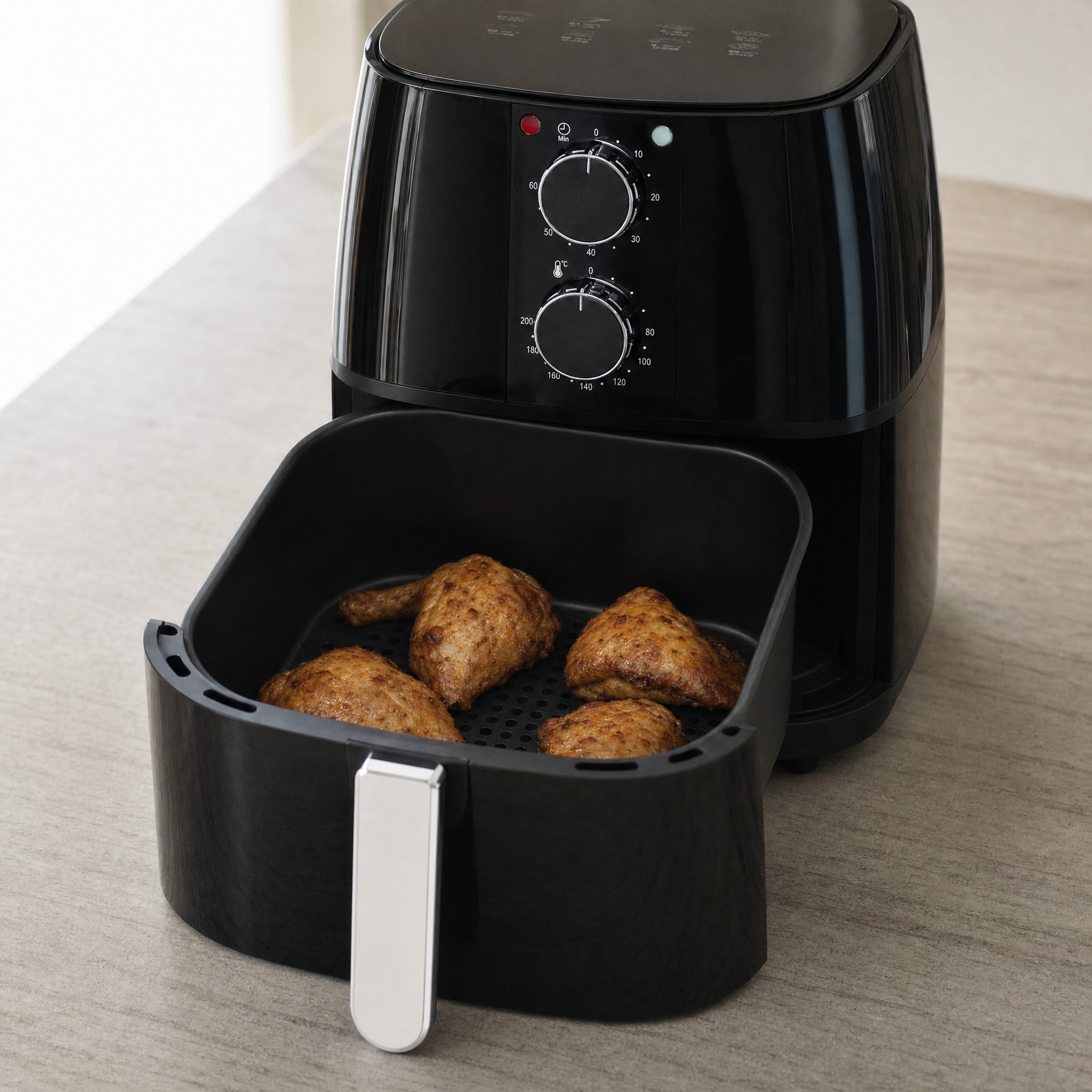 Domestic King 4L air fryer with its drawer pulled open, showing crisp cooked chicken sitting in the perforated non-stick basket
