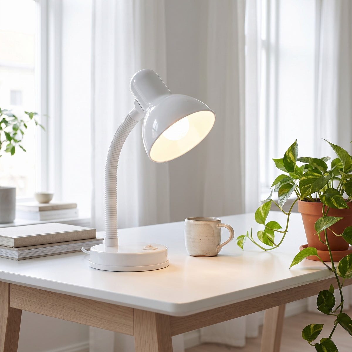 Lloytron 35W Classic Flexi desk lamp, white, lit on a bright white desk