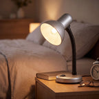 Lloytron 35W Classic Flexi desk lamp, silver, lit on a bedside table