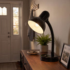 Lloytron 35W Classic Flexi desk lamp, black, lit on a hallway console table