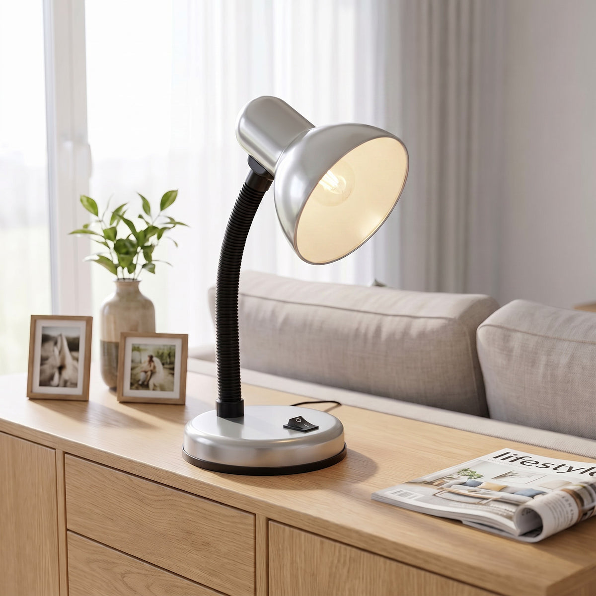 Lloytron 35W Classic Flexi desk lamp, silver, lit on a living room sideboard